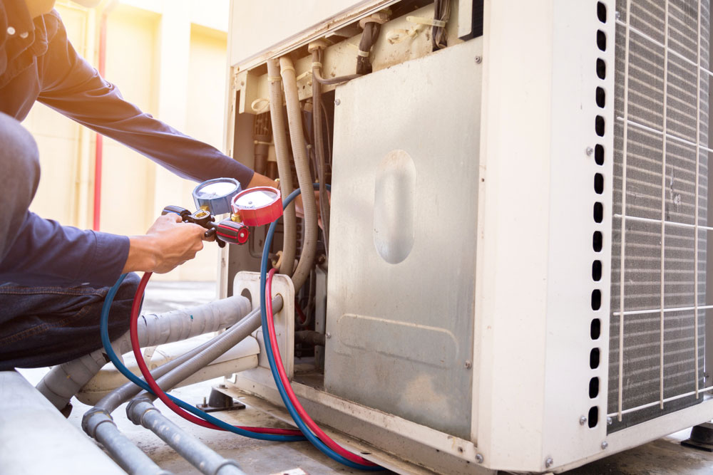 Technician checking air conditioner